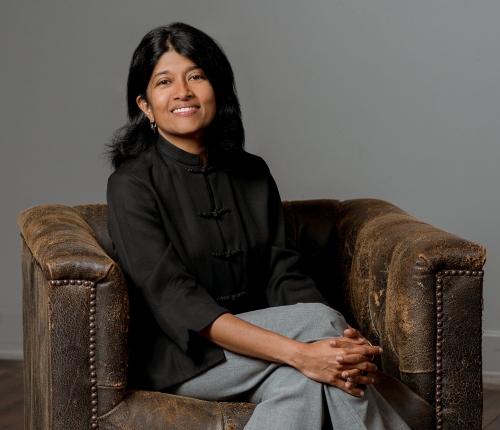 portrait of Sampriti Ganguli sitting in a brown chair 